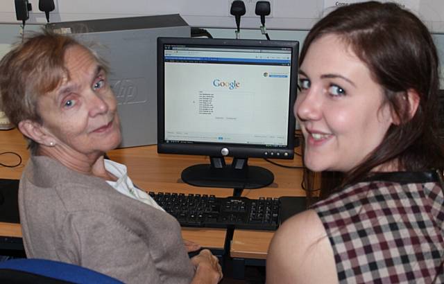 Dorothy Short receives some IT advice from RBH volunteer Lucy Hinchcliffe