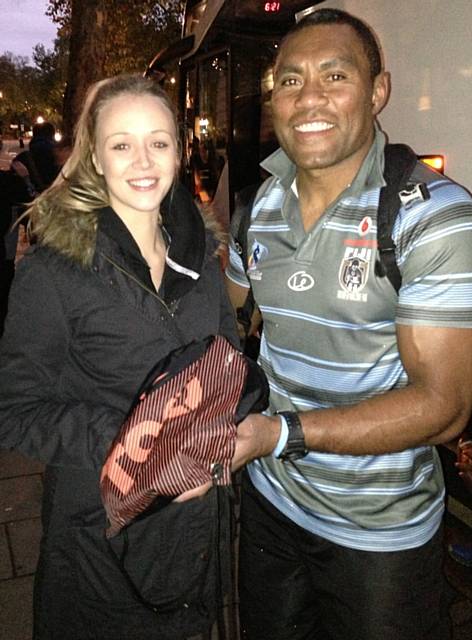 Fiji Bati captain and world Rugby League legend Petero Civoniceva presents Rochdale Hornets member Megan Tann with his boots after the World Cup Semi Final at Wembley