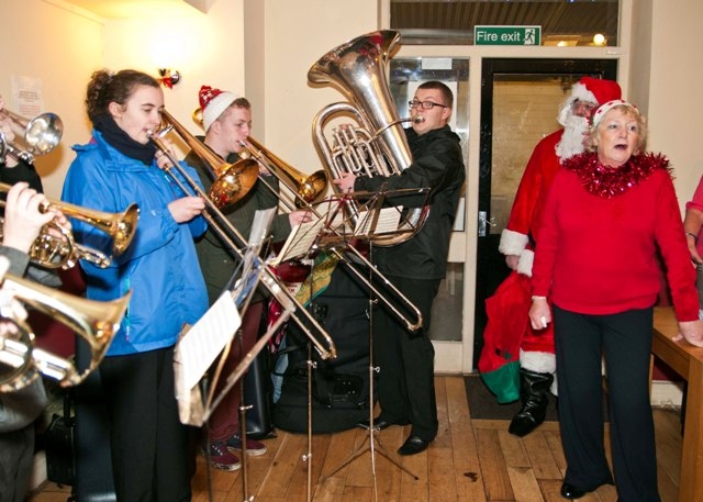 Dozens of Norden villagers braved the rain to sing Christmas carols and kick off the Yuletide week