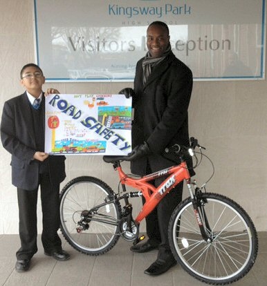 Mr V Walters Head of PSHCE and CEIAG, with Zubair after collecting his mountain bike