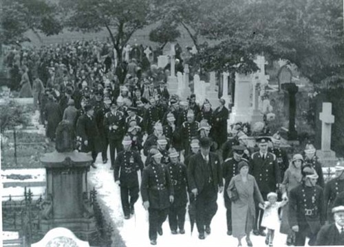 Mourners attend the funeral of fire volunteer Paddy Kelly