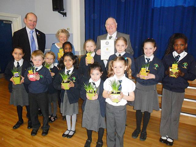 President Jeff Lawton, Rotarians' Keith Trinnaman & Jean Nott, along with the represenatives from somne of the classes having received their potted crocus plants