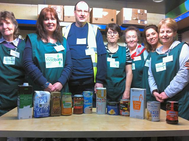 Rochdale Foodbank Volunteers with items of food we are really short of