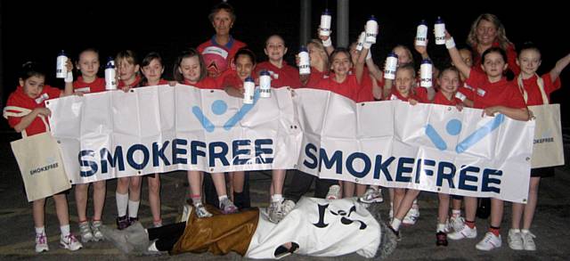 Rochdale Under 9 Netball Team sporting smoke free wristbands, water bottles, bags and banner with Angela Jagger, coach and Sarah Gouldbourne, Enforcement Officer 