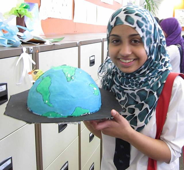 Ayesha Irfan holding her final piece of work inspired by the family tree project