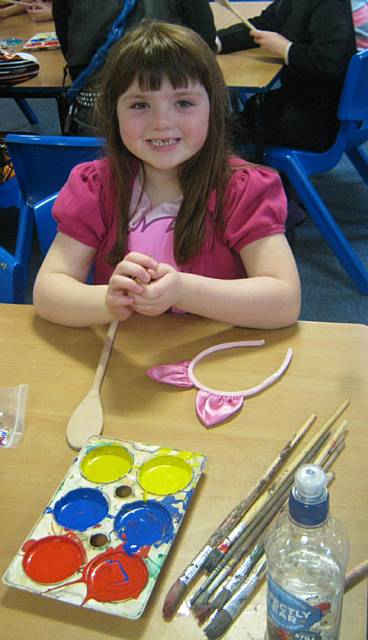 Ebony making a wooden spoon puppet for the show