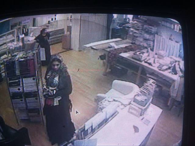 Women in Tilly's Tea Room at 3:25pm Tuesday 23 April when charity bottle went missing