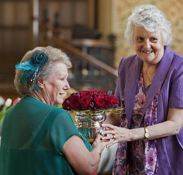 2012 winner Carol Hartley, of Heywood (right) presents the Rochdale Woman of the Year 2013 rose bowl to Doreen Stott