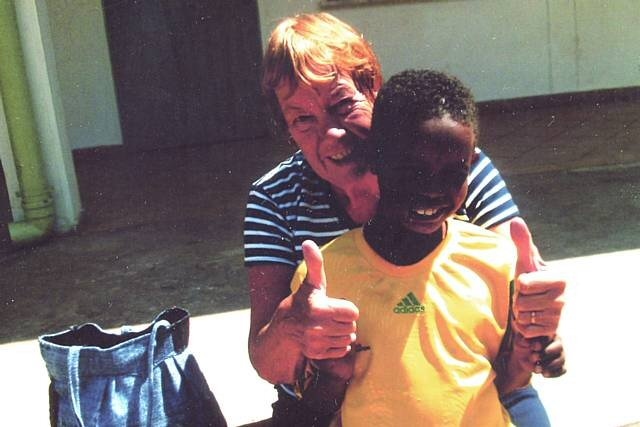 Anne McNicholas with a child during a visit to Ethiopia