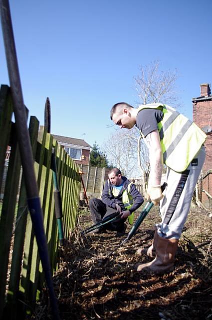 Green Team participants cleaning land at homes near Milnrow