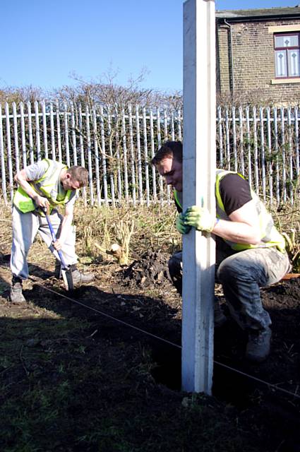 Green Team participants cleaning land at homes near Milnrow