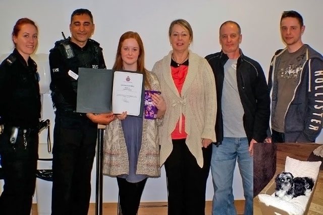 Samantha Hammond receiving her Police Certificate of Merit from Inspector Umer Khan