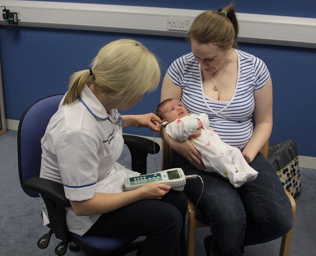 Kristel Bevan, Newborn Hearing Screener for Pennine Care and mum Althea Lyons with five week old baby Isla