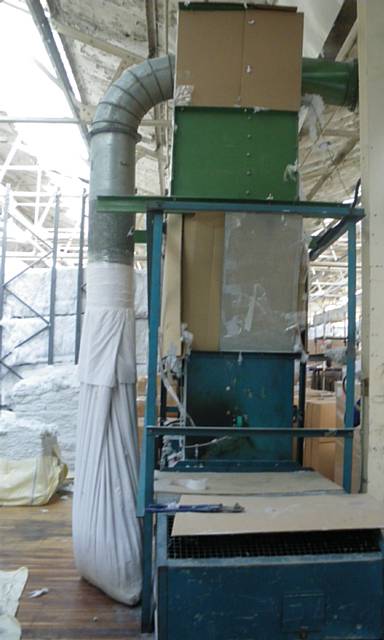 One of the machines at the factory which had been wrapped with pieces of cardboard as the only way of protecting workers from the dangerous moving parts inside