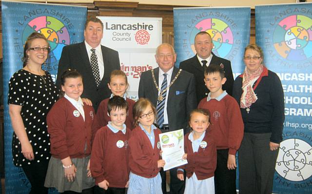 The Eco-School Council from St John with St Michael CE Primary School in Shawforth, Miss Kenyon (Eco-Council coordinator), Mrs Driver (Eco-Grounds project maintenance manager), Mr Sims (Governor) and Mr Entwistle (Chair of Governors and also a road traffic police officer)