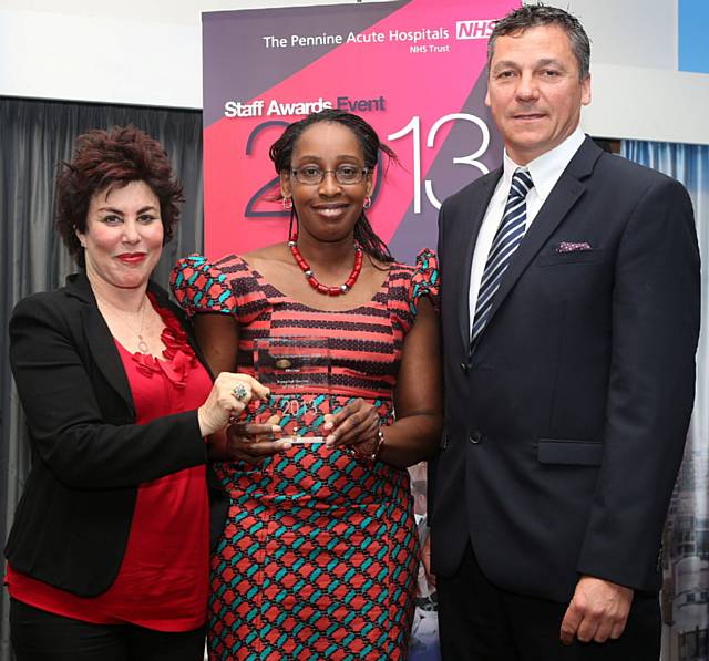 Dr Bibian Ofoegbu receives the Hospital Doctor of the Year Award from Ruby Wax and Roy McIver of NG Bailey