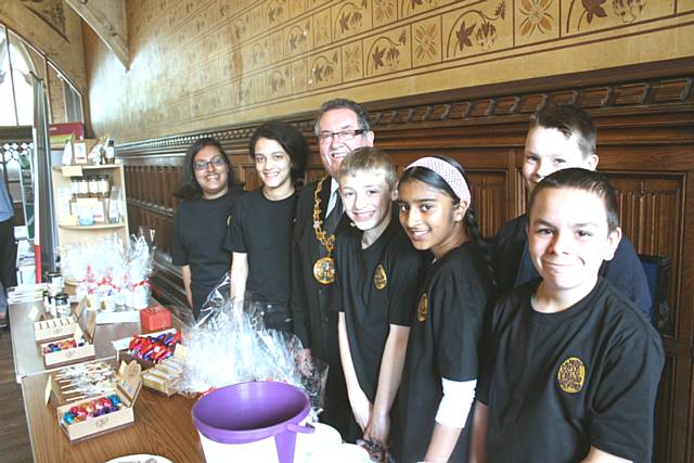 Young RBH tenants show the Mayor of Rochdale, Cllr Peter Rush, their “Not Just A Little Business” fair trade stall while celebrating Co-operatives Fun Day in Rochdale Town Hall