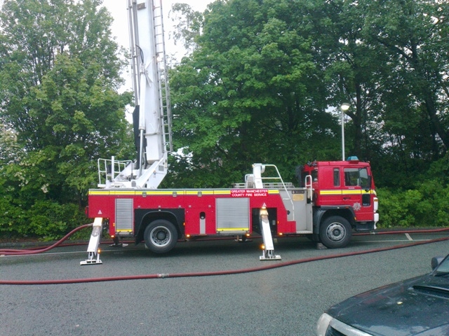 Fire-fighters using a fully extended ladder to fight the blaze