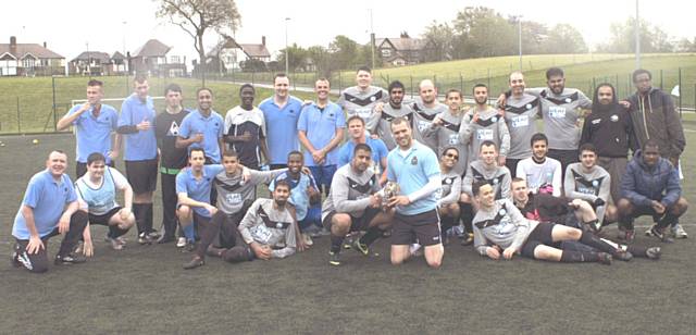 Deaf Rhinos FC and Hopwood Hall Sports Arena staff team. Rhinos captain Gaz Safdar and Stuart Parry from Hopwood Hall Sports Arena share the trophy after the friendly challenge match finished 4-4