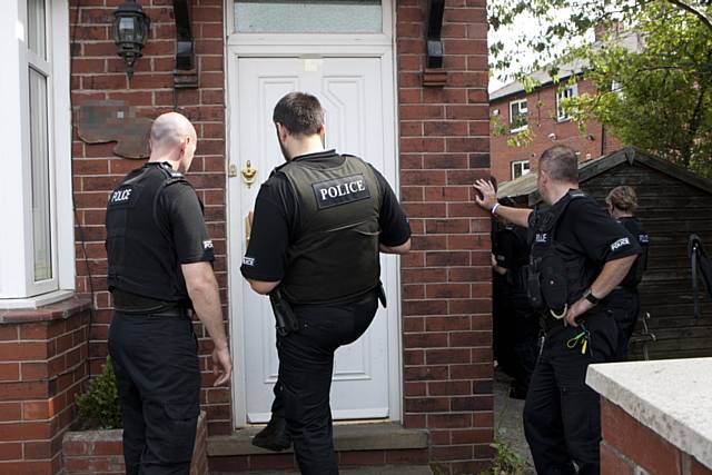 Police raiding a house during Operation Resolute