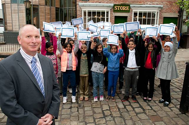 Pupils from Heybrook and Broadfield Primary Schools receiving their participation certificates from TfGM’s Rochdale Bus Station Manager, Paul Clough, at Rochdale Pioneers Museum