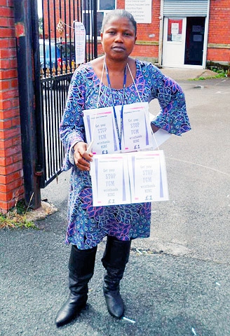 Mary Adenugba (also helped by RAPAR) selling stop FGM wristbands