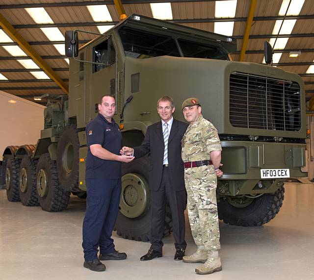 Sponsored Reservist Carl Linthwaite with a repaired Oshkosh handing back to Brig Peter Rafferty with CCE's Phil Ewbank