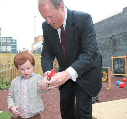 Simon Danczuk MP with his son Morris cutting the ribbon to officially open the outdoor play area