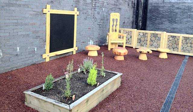 The new story corner, complete with toadstools to sit on, part of the new outdoor play area at the crèche at Hopwood Hall College 