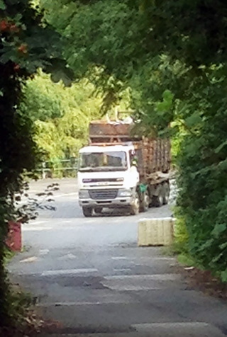 Unsheeted fully loaded wagon  after it had reversed back down Spod Road (TBA site exit road). The photograph was taken at about 3.30pm Wednesday (27/8/13) from the highway on Rooley Moor Road. In the area around the nearside front wheel arch a green sheet can be seen neatly folded. This is the cover sheet that was attached to the wagon 10 minutes later.