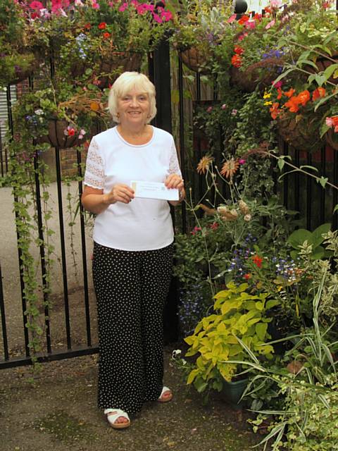 Bernice Clark, winner of Rochdale’s Alley in Bloom Competition 2013, surrounded by some of the stunning plants and flowers she and friend Sue Thomas have introduced to transform a previously vandalised alleyway