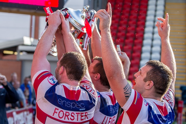 The Hornets players take the cup to their supporters in the stand