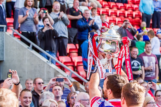 The Hornets players take the cup to their supporters in the stand