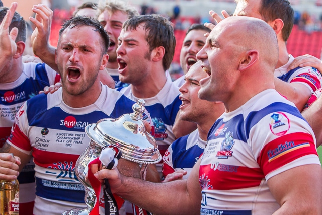 The Hornets players take the cup to their supporters in the stand