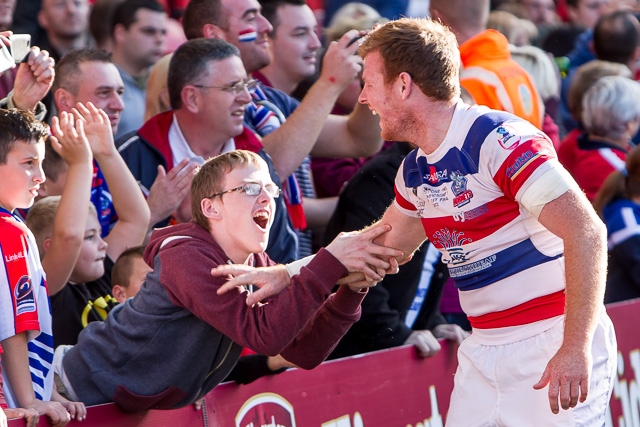 Paul Crook congratulated by an ecstatic young Hornets supporter