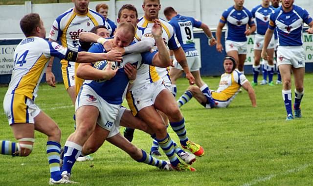 Callum Marriott held by four Oulton players 