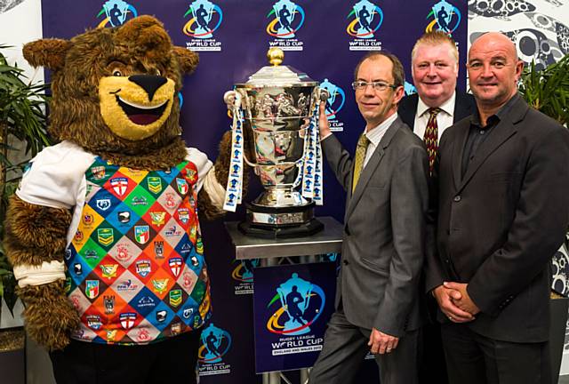 Council Leader Colin Lambert, Link4Life Vice-Chair Kevin Finnegan and Link4Life Manager John Taylor with The Rugby League World Cup 2013 trophy and ‘Grubber’ the tournaments official mascot