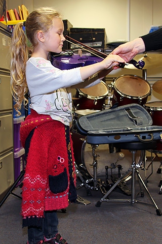 Rochdale Music Service Open Day<br /> Lily Davies tries the violin