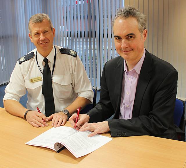 Gareth Swarbrick and Paul Starling sign the information-sharing agreement
