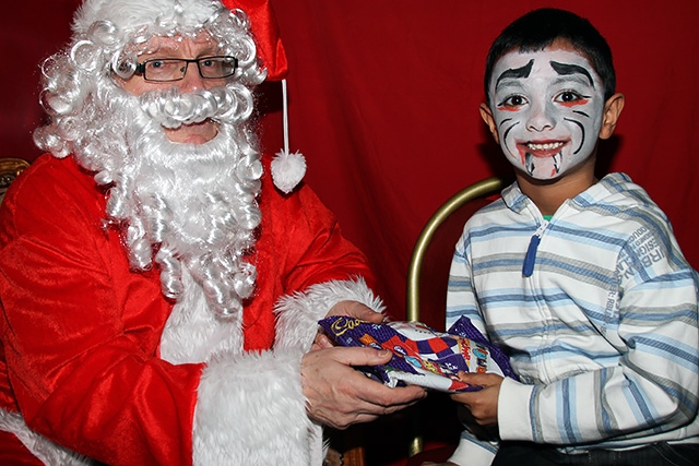 Rehan Hussain meets Father Christmas at the Freehold Community Group jingle bell ball