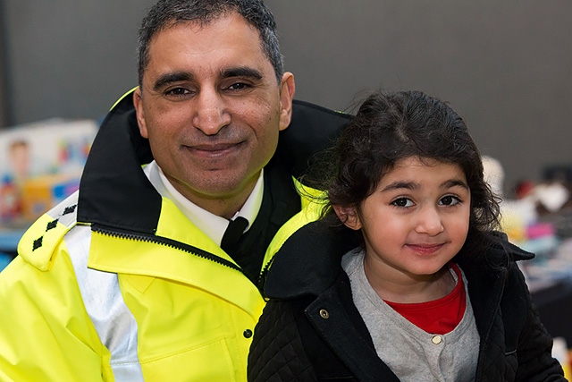 Chief Inspector Umer Khan with one of the children at the  Shamwari Project Secret Santa event