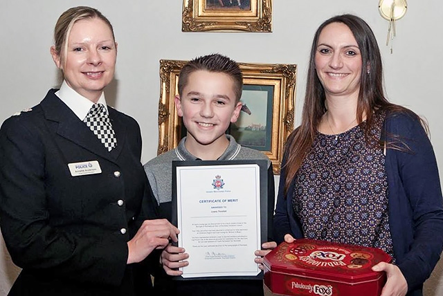 Lewis Threlfall receiving his Rochdale Division Commander's Certificate from Chief Superintendent Annette Anderson