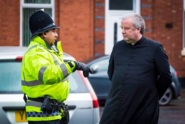 Police talk to Father Paul Daly at St Joseph’s 