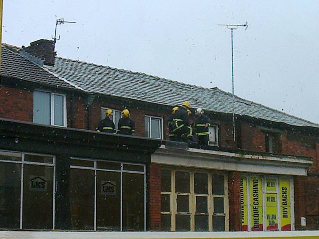 Fire crews on the roof of the old Health Food Shop at the top of Yorkshire Street 