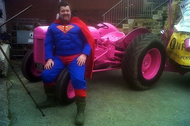 Mark Wickham dressed as Superman with his pink tractor