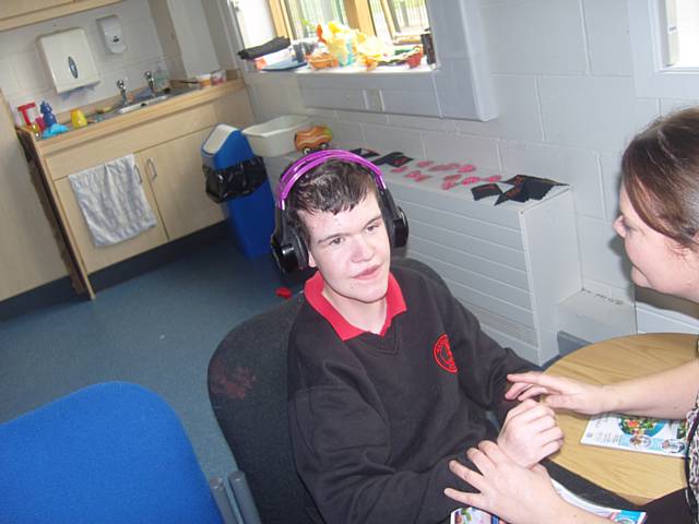 Pupil listening to the audio from the video they made of 'Not the smartest dog alive' 