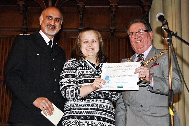 Sophie Hepworth-Wrigley being presented with the Personal Achievement Award by Mayor Peter Rush watched by Chief Inspector Nadeem Mir