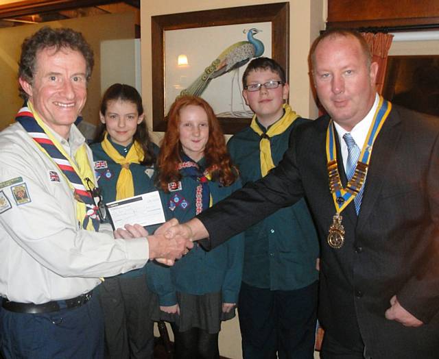 Rotary Club of Heywood President Phil Corns handing the cheque to Craig Pullen with Scouts Cara Walch, Cerys Shackleton and Kieran Butterworth
