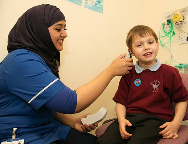 Young patient Tyla Warburton, 5 years old from Rochdale and a pupil from Whittaker Moss Primary School, with staff nurse Rabia Khanam at the Urgent Care Centre