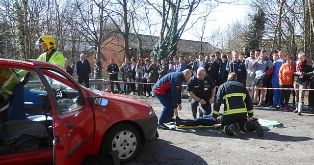 Students watch a simulated car crash helped by the local fire service as part of Stay Safe Week